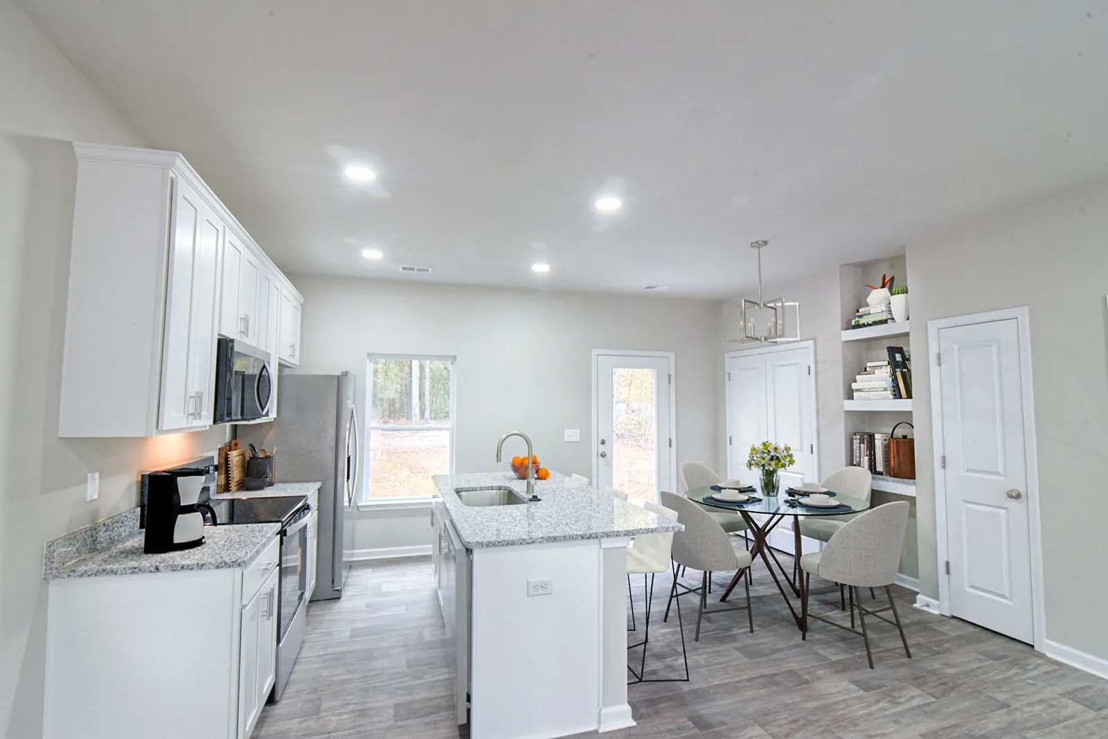 Virtually staged kitchen and dining area in The Maple.